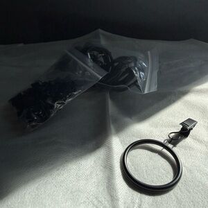 Set of 21 classic black curtain rings with clip. New never used.